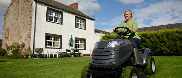 Independent senior mows lawn